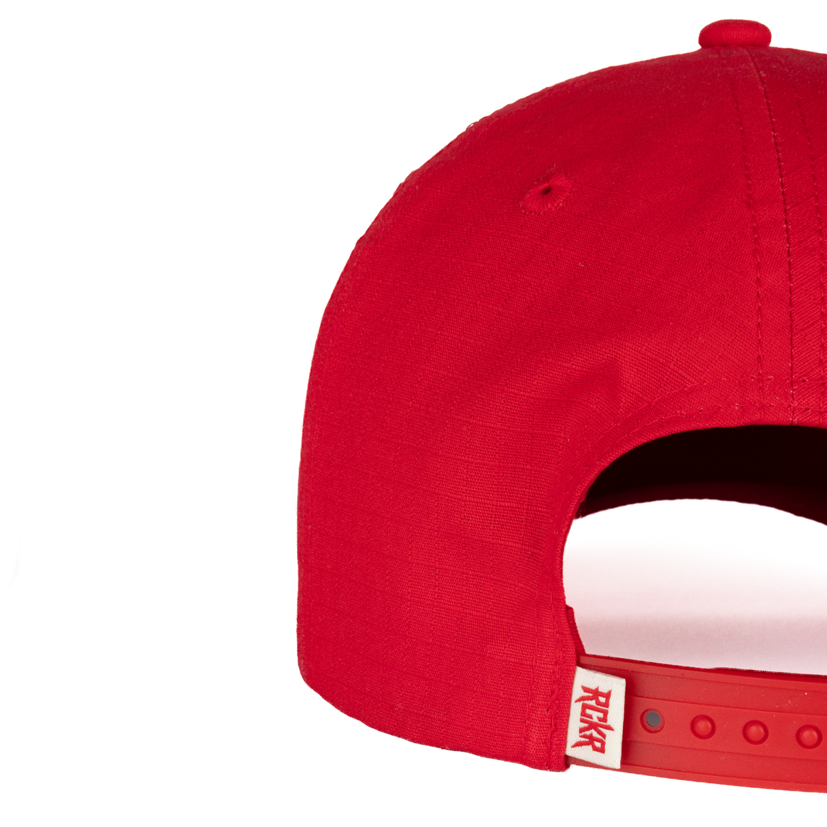 Closeup of RCKR label on back of red hat